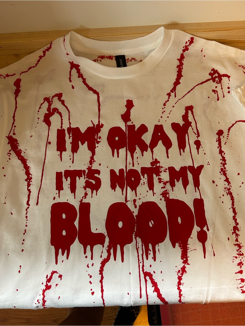 White Short Sleeve Graphic Tee with Red 'I'm Okay It's Not My Blood' Print